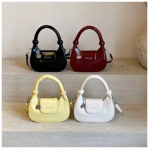 Row of minimalist half-moon crossbody bags in black, burgundy, yellow and white