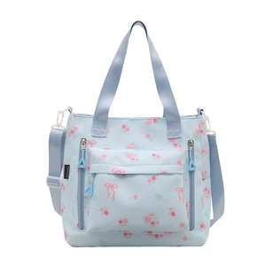 Light blue floral tote bag with pink flower patterns and adjustable shoulder strap