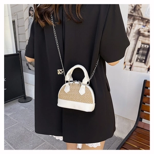 Detailed view of mini shell bag with woven texture, PU leather and silver chain