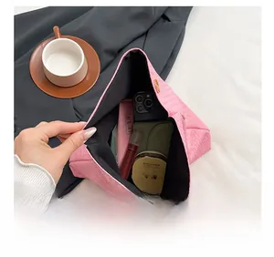 Pink woven clutch bag interior view showing large storage capacity for daily essentials