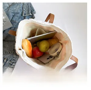 Top view of white woven tote bag interior showing large capacity for daily items
