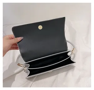 Vue détaillée de la pochette enveloppe argentée avec double compartiment et fermoir aimanté