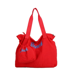 Large red nylon beach tote bag with matching drawstring pouch and blue Beach text