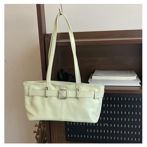 Detail of pistachio green leather underarm bag with decorative silver buckle