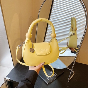 Minimalist ginger yellow half-moon crossbody bag with decorative beads and G pendant