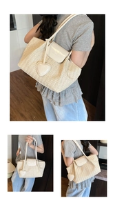 Detail of woven straw tote bag with white leather flap and large heart charm accessory