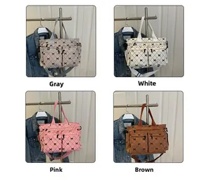 Quilted tote bags shown in four colors featuring a black bow pattern and double zippers