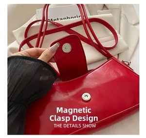 Close-up of magnetic buckle design and red patent leather texture on shoulder bag