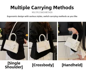 Detailed close-up of a two-tone crossbody tote bag with adjustable shoulder strap and handle