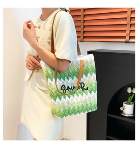 Close-up of woven tote bag with green wavy stripes and Summer embroidery detail