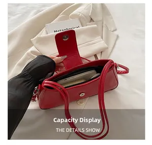 Detailed interior view of red underarm bag showing capacity for phone and wallet