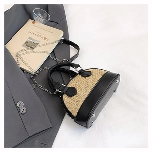 Detail view of mini shell bag showing contrasting beige weave and black leather textures