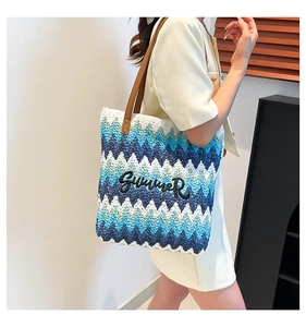 Detail of colorful woven tote bag with Summer embroidery and stylish leather handles
