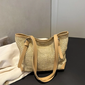Minimalist beige woven tote bag with hollow mesh design and brown leather trims
