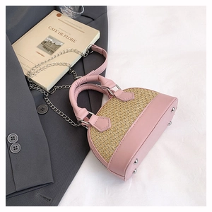 Detail of pink leather and woven straw shell bag with metal protective base studs
