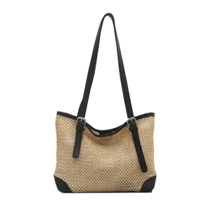 Handwoven straw tote bag with black leather straps and reinforced corners for summer beach