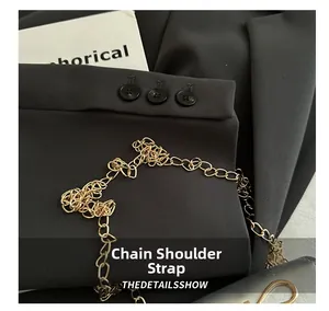 Detail shot of the sturdy gold-toned metal chain strap on a women's mini square bag