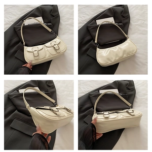 Detailed views of a cream white PU leather baguette bag with dual buckle front pockets