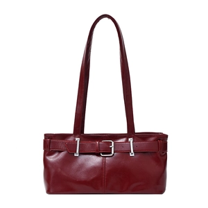 Deep red patent leather underarm bag with large silver buckle and glossy finish