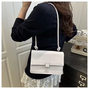 Detailed back view of white crocodile pattern shoulder bag with decorative square buckle