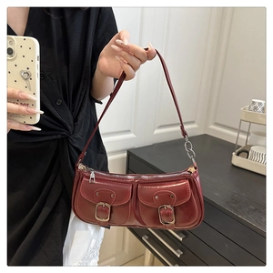 Close-up of wine red Y2K shoulder bag with glossy oil wax leather and silver hardware