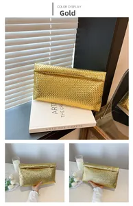 Macro detail of the gold woven checkerboard texture on the large envelope clutch bag