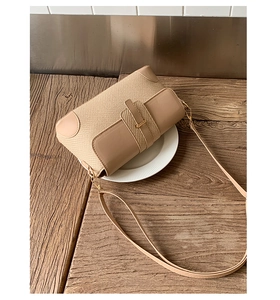 Detail of the woven texture and smooth PU leather stitching on a vintage shoulder bag