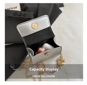 Silver metallic mini chain bag showing storage capacity for lipstick and earbuds