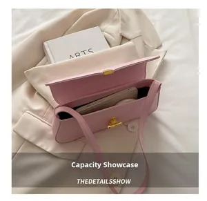 Detailed view showing pink baguette bag interior capacity with a smartphone inside
