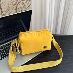 Minimalist bright yellow lightweight nylon crossbody bag with wide shoulder strap
