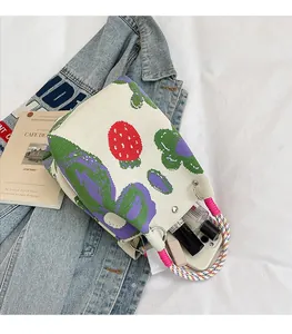 Close-up of knit tote bag showing interior space with phone and cosmetic items