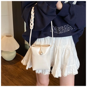 Mini cream crossbody phone bag with large pearl buckle and chain strap detail