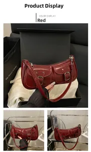 Detail view of red glossy baguette bag with double front pockets and silver buckles