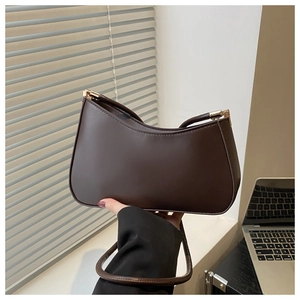 Detail of dark brown leather hobo bag featuring golden hardware and retro half-moon shape