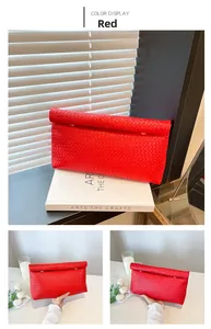 Detail of red woven envelope clutch showing premium grid texture and magnetic flap closure
