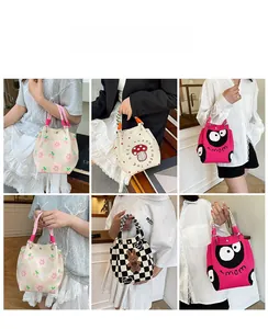 Detail of knitted tote bags featuring cherry, mushroom, and checkered patterns with thick handles
