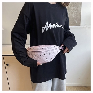 Close-up detail showing the light purple fabric waist bag with cute black bow pattern