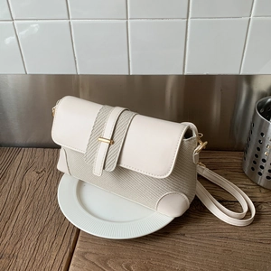 French vintage shoulder bag with textured weaving and beige leather flap detail