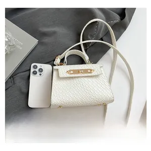 Detailed size comparison of a mini white crocodile pattern bag with a smartphone