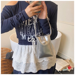 Silver metallic mini crossbody phone bag with chunky chain handle and pearl buckle detail
