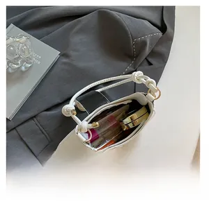 Detailed interior of black and white saddle bag showing capacity for cosmetics