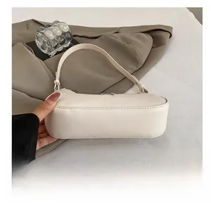 Detailed macro view showing the durable wear-resistant bottom of the off-white crescent bag