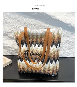 Macro detail of rainbow wave pattern woven straw tote with Summer embroidery and leather handles
