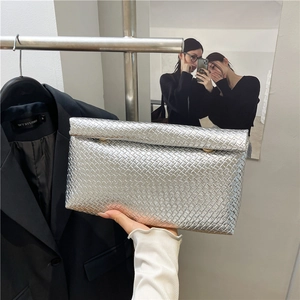 Elegant silver woven envelope clutch bag with metallic texture and snap closure