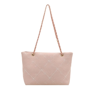 Pink quilted tote bag with floral embroidery and gold chain strap on white background
