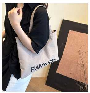 Close-up of FANYISSA large canvas tote bag showing thick texture and shoulder strap fit