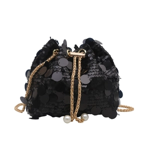 Elegant black sequin bucket bag with gold chain strap and pearl drawstring details
