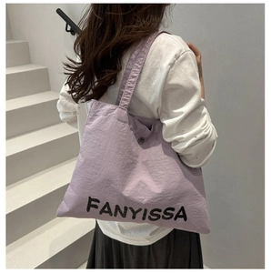 Macro detail of lavender tote bag with FANYISSA lettering and textured durable fabric