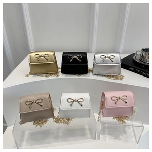 Close-up of bow-knot hardware details on six colors of mini chain shoulder bags