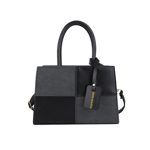 Modern two-tone rectangular handbag with black and grey patchwork design and shoulder strap